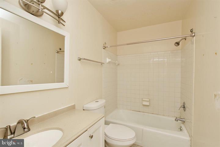 1818 Bryant Street Northeast Washington, DC 20018 - Photo 9 of 12 a bathroom with a sink toilet a mirror and shower