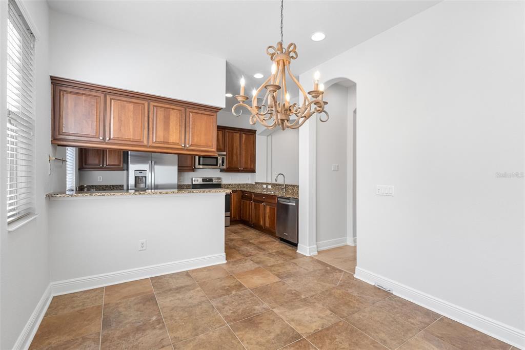5902 Printery Street, Unit 105 Tampa, FL 33616 - Photo 20 of 54 a kitchen with kitchen island granite countertop stainless steel appliances cabinets a sink and a counter top space