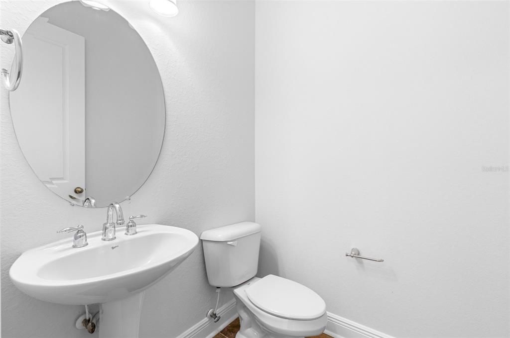 5902 Printery Street, Unit 105 Tampa, FL 33616 - Photo 21 of 54 a bathroom with a sink a toilet and mirror