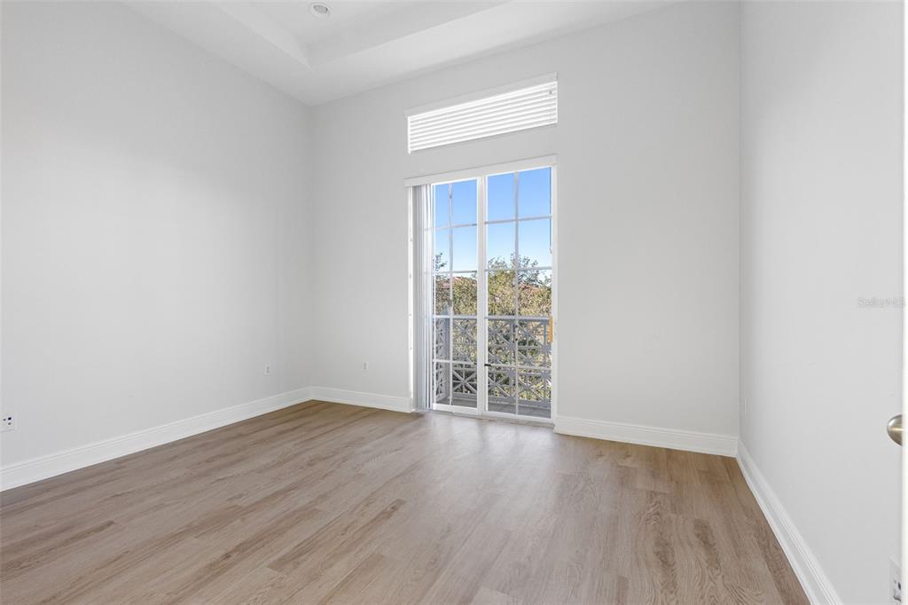 5902 Printery Street, Unit 105 Tampa, FL 33616 - Photo 23 of 54 an empty room with wooden floor and windows