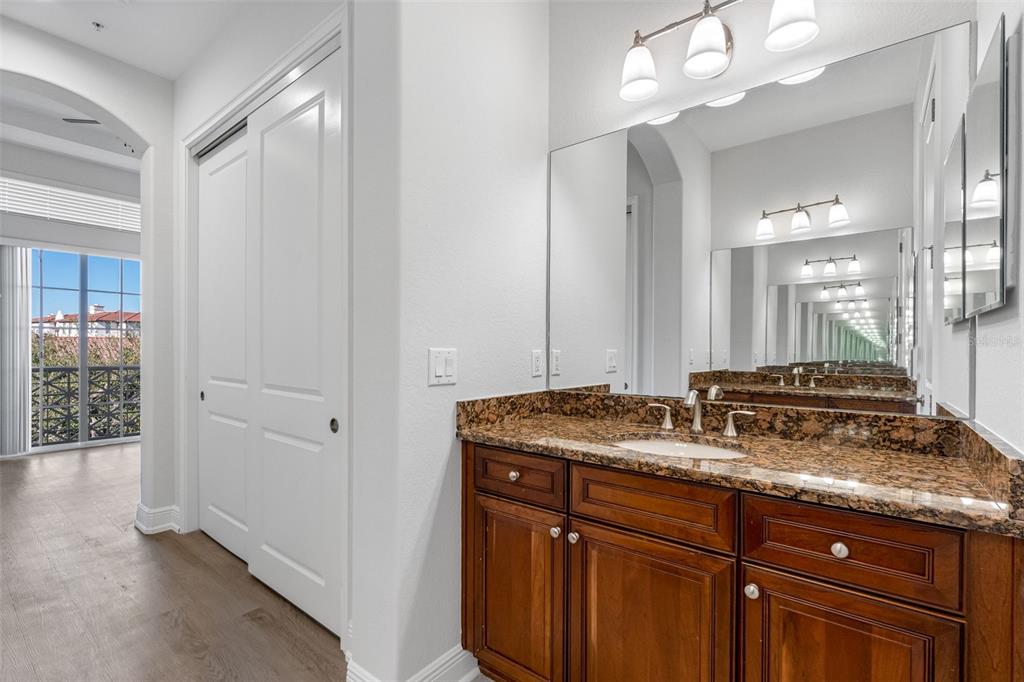5902 Printery Street, Unit 105 Tampa, FL 33616 - Photo 30 of 54 a bathroom with a granite countertop sink and a mirror