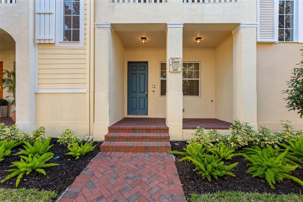 5902 Printery Street, Unit 105 Tampa, FL 33616 - Photo 3 of 54 a front view of a house with a yard