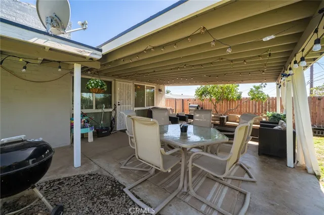 a view of a house with swimming pool and porch with furniture