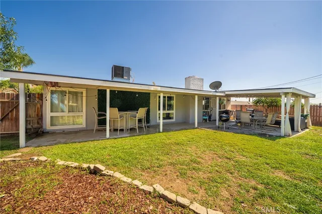 a view of a swimming pool with a bench and lawn chairs