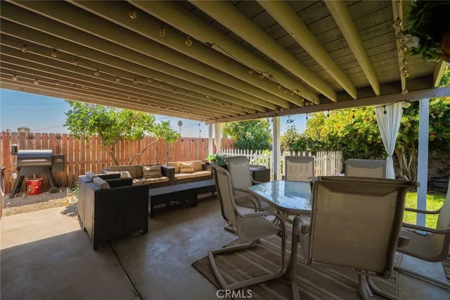 a swimming pool with outdoor seating and yard