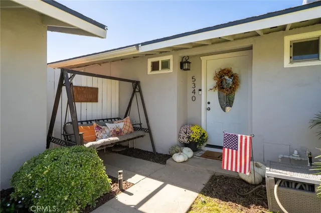 a backyard of a house with outdoor seating