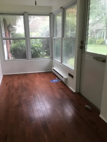 an empty room with a window and a ceiling fan
