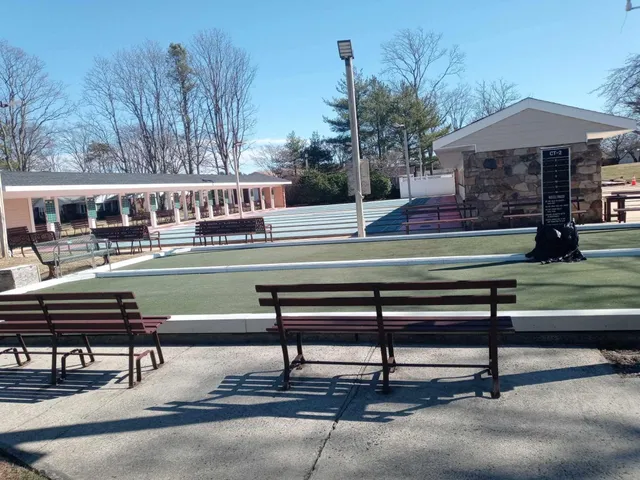 a swimming pool with outdoor seating outdoor space and trees
