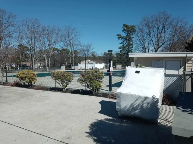 a street sign on a sidewalk next to a road