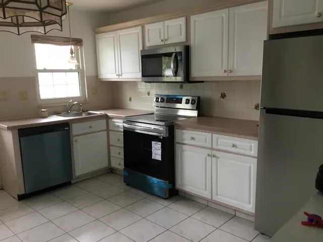 a kitchen with a cabinets and window