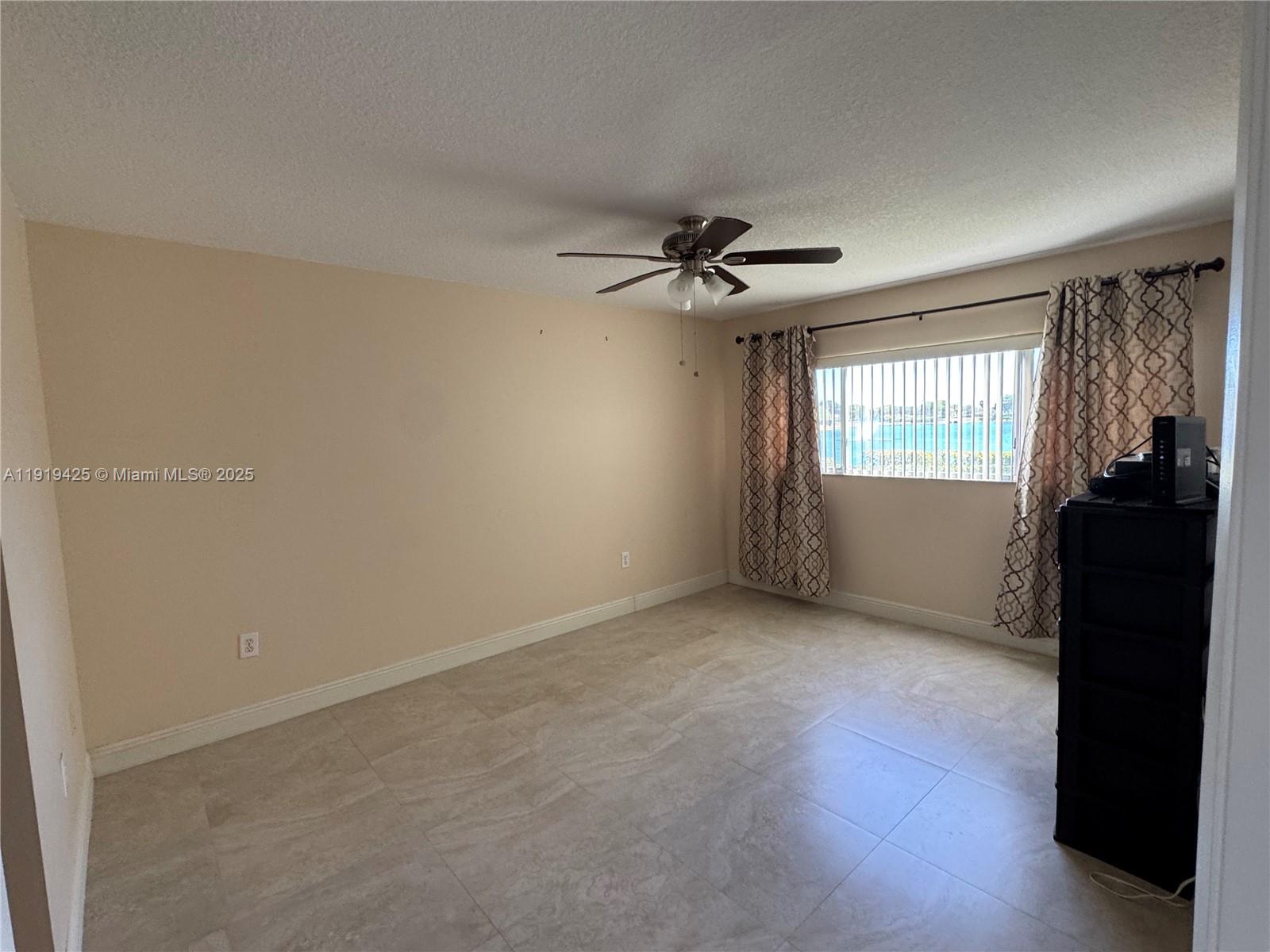 1001 Southwest 141st Avenue, Unit 107K Pembroke Pines, FL 33027 - Photo 15 of 28 a view of empty room with windows
