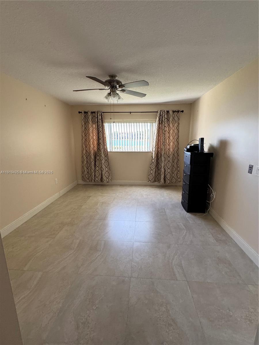 1001 Southwest 141st Avenue, Unit 107K Pembroke Pines, FL 33027 - Photo 16 of 28 a view of empty room with a window