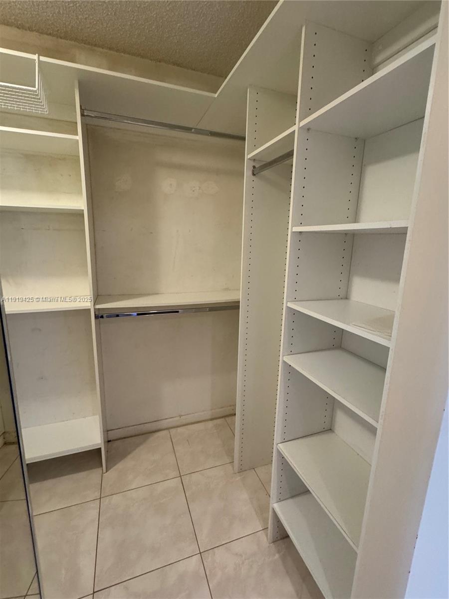 1001 Southwest 141st Avenue, Unit 107K Pembroke Pines, FL 33027 - Photo 17 of 28 a view of an empty walk in closet