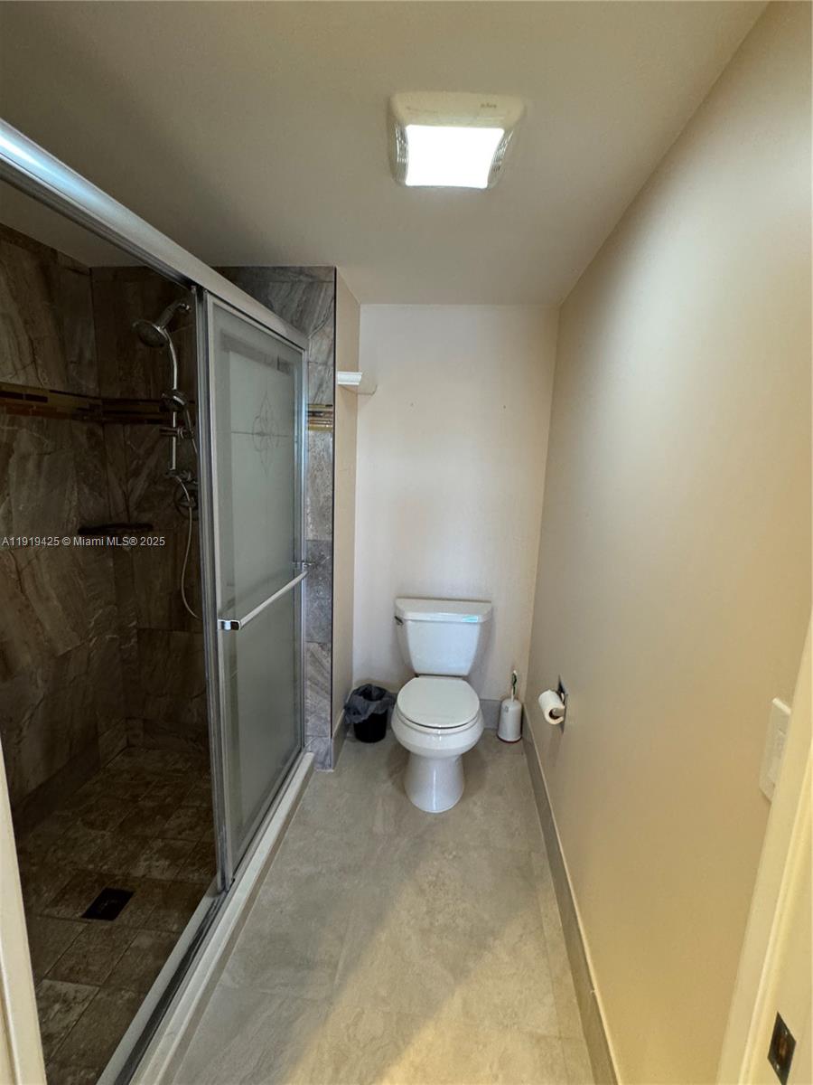 1001 Southwest 141st Avenue, Unit 107K Pembroke Pines, FL 33027 - Photo 20 of 28 a bathroom with a toilet and a shower
