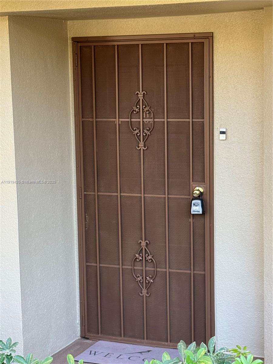 1001 Southwest 141st Avenue, Unit 107K Pembroke Pines, FL 33027 - Photo 2 of 28 a view of a wooden door