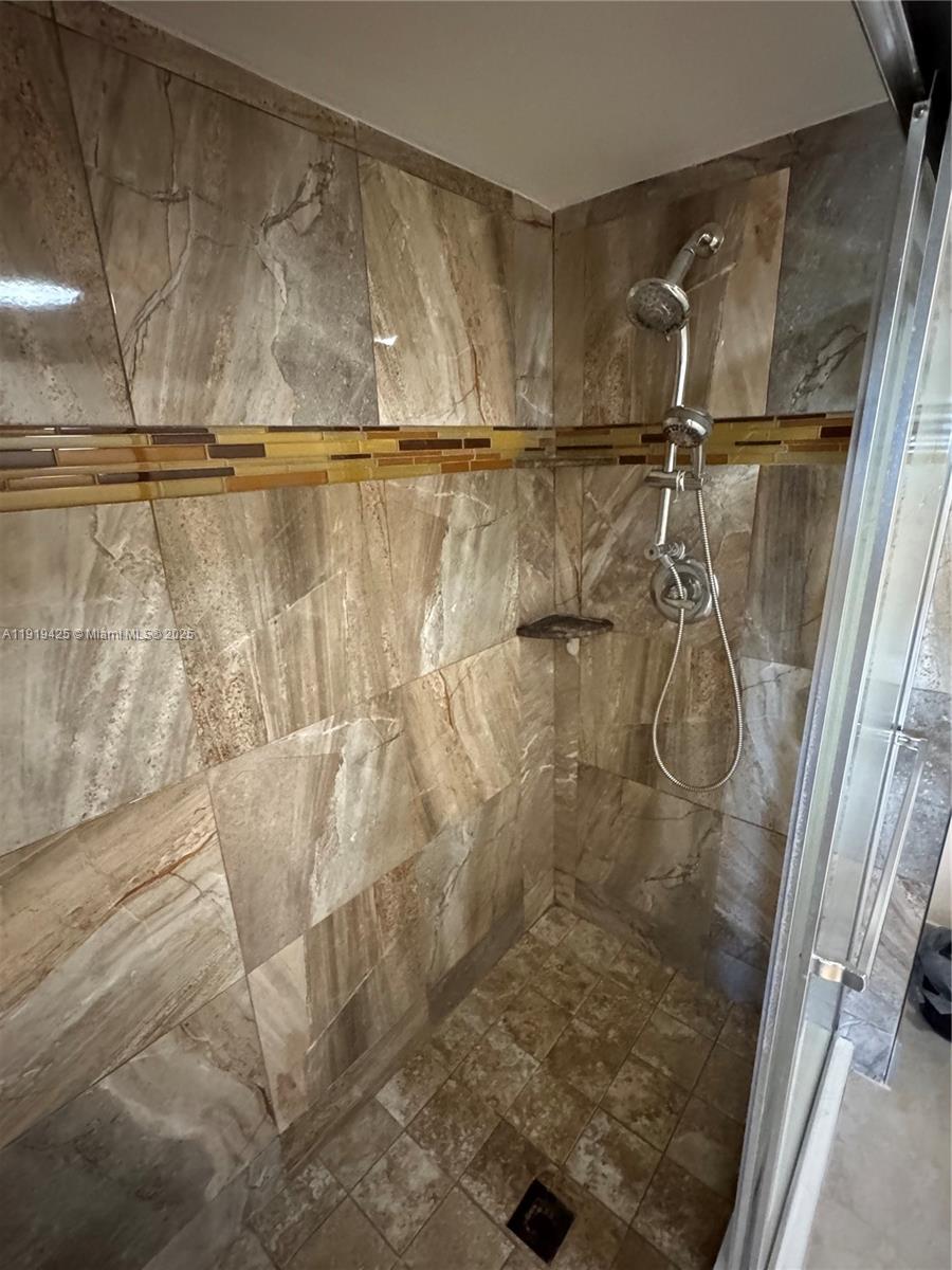 1001 Southwest 141st Avenue, Unit 107K Pembroke Pines, FL 33027 - Photo 23 of 28 a bathroom with a shower