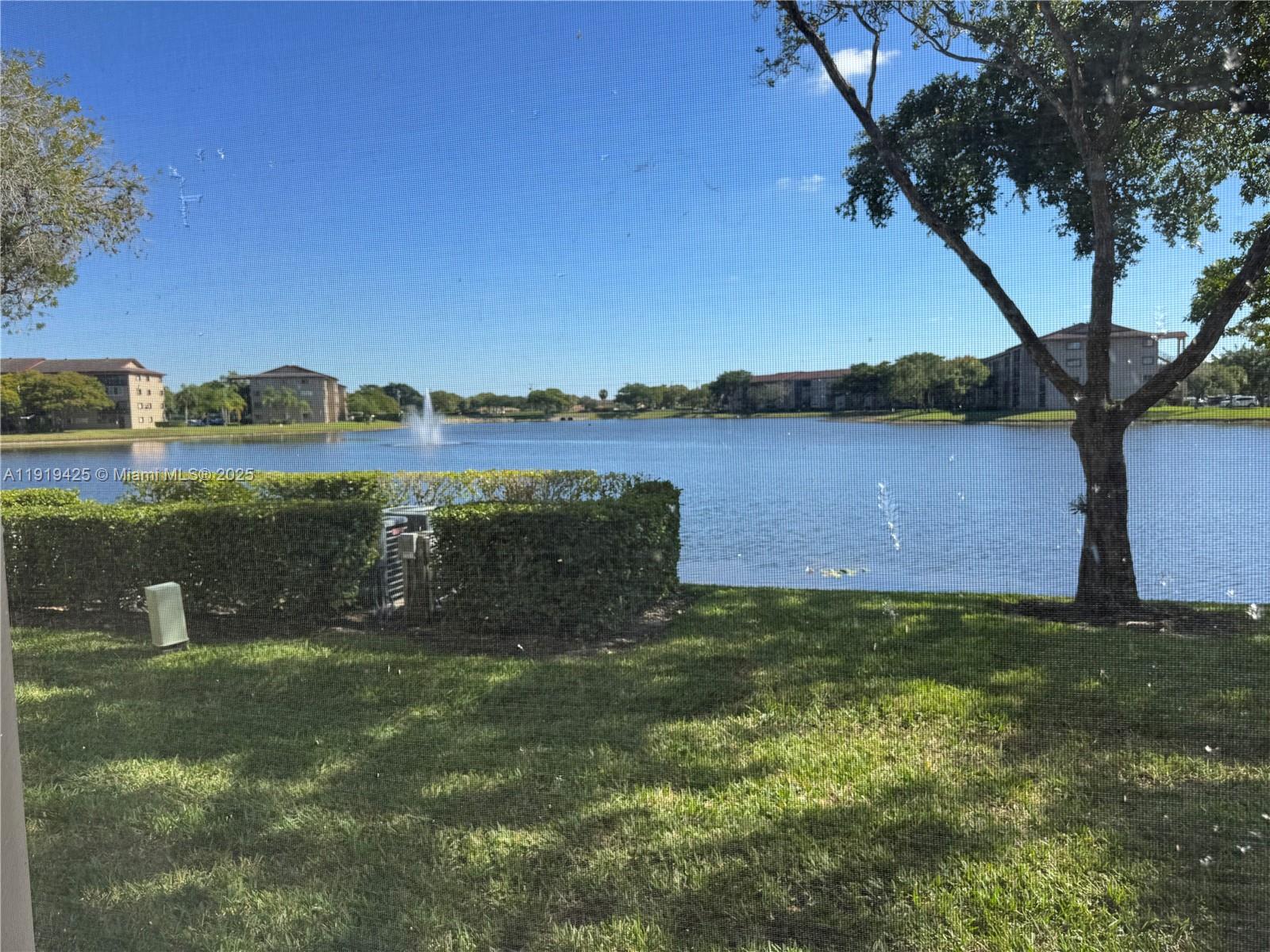 1001 Southwest 141st Avenue, Unit 107K Pembroke Pines, FL 33027 - Photo 25 of 28 a view of lake with mountain in the background
