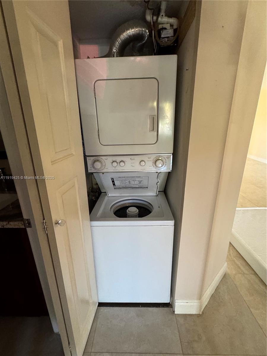 1001 Southwest 141st Avenue, Unit 107K Pembroke Pines, FL 33027 - Photo 5 of 28 a utility room with dryer and washer