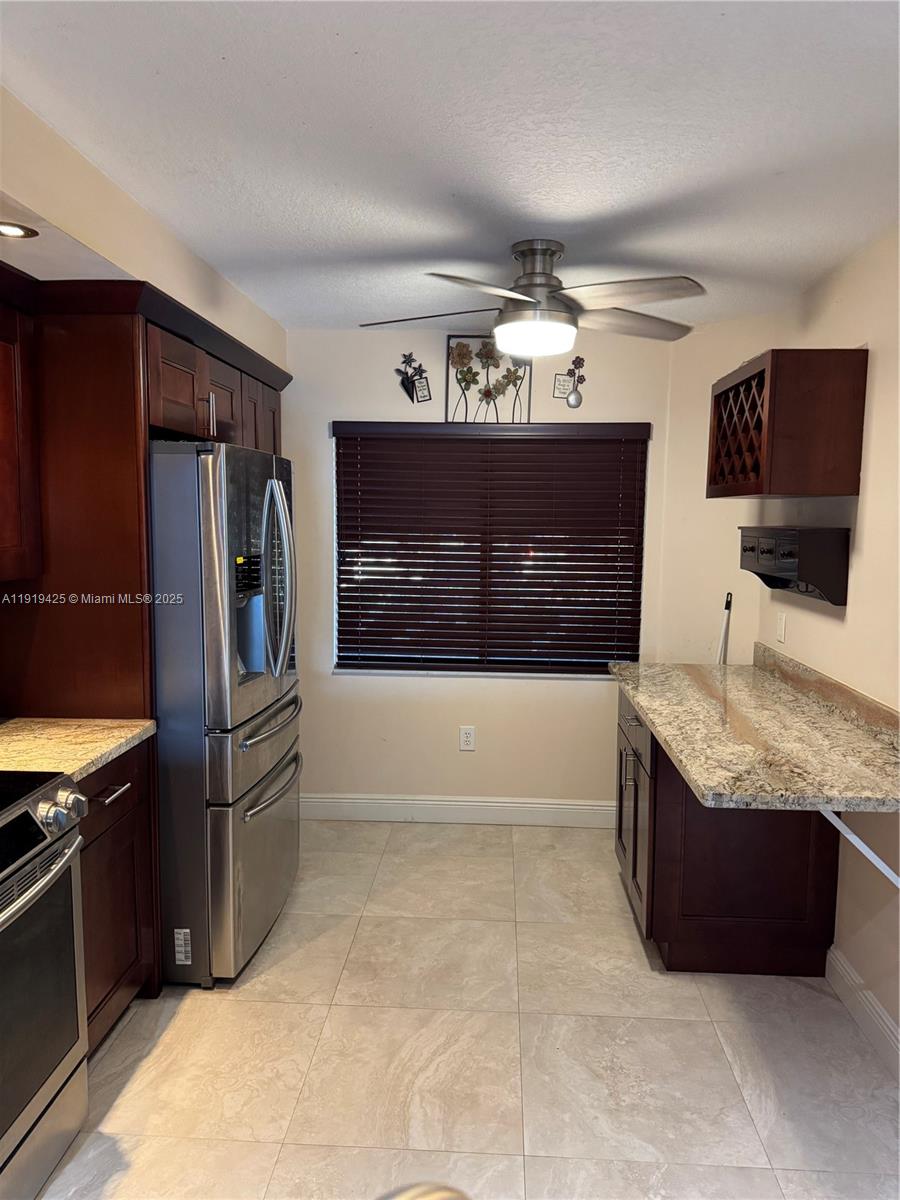 1001 Southwest 141st Avenue, Unit 107K Pembroke Pines, FL 33027 - Photo 7 of 28 a kitchen with stainless steel appliances granite countertop a refrigerator and a sink