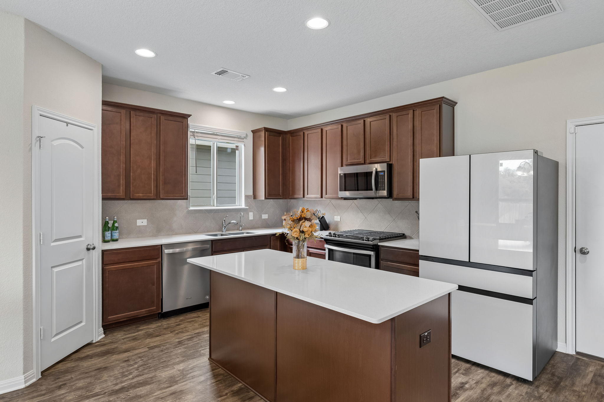 809 Whitman Avenue Georgetown, TX 78626 - Photo 15 of 35 a kitchen with kitchen island a sink stove and refrigerator