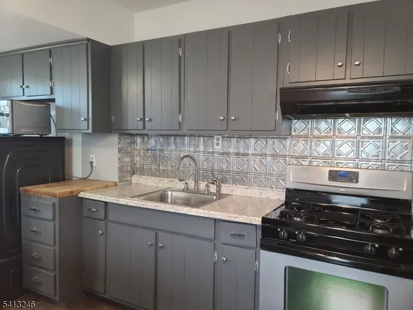 a kitchen with granite countertop cabinets and steel stainless steel appliances