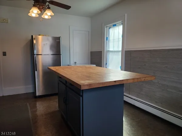 a kitchen with a refrigerator and countertop