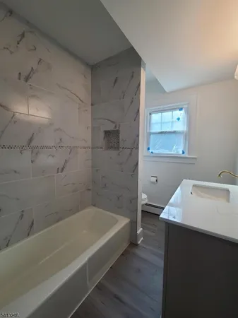 a bathroom with a bathtub and a sink