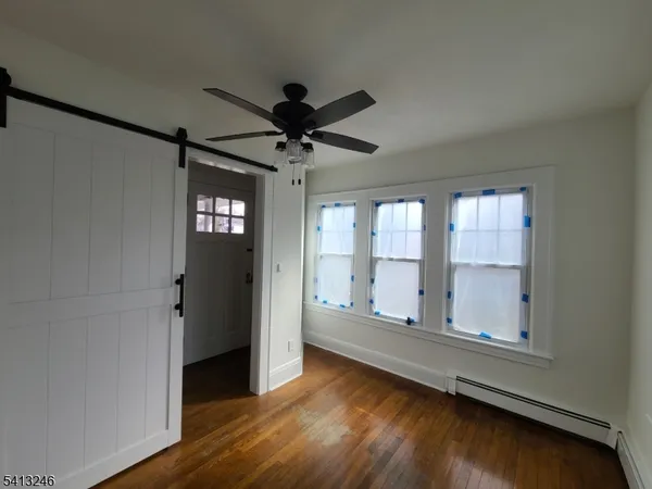 a view of room with window and wooden floor