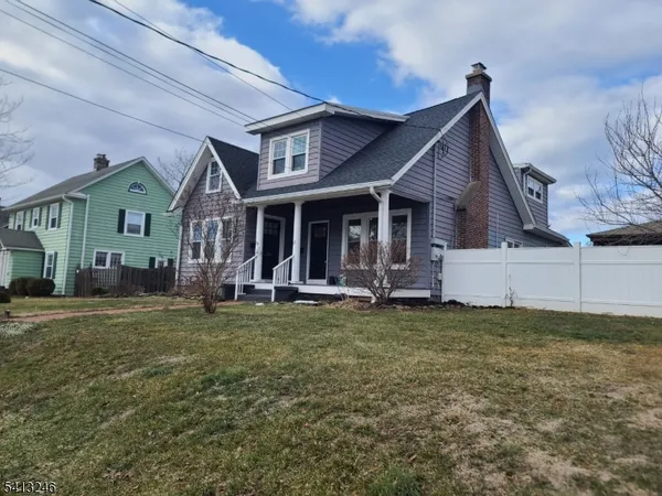 a view of a house with a yard and deck