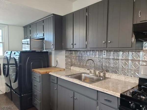 a kitchen with a sink and cabinets