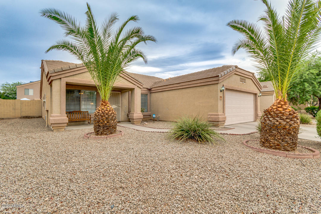 12714 West Calavar Road El Mirage, AZ 85335 - Photo 2 of 24 a front view of a house with a garden