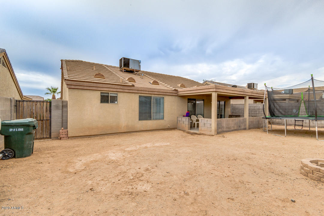 12714 West Calavar Road El Mirage, AZ 85335 - Photo 22 of 24 a front view of a house with a patio