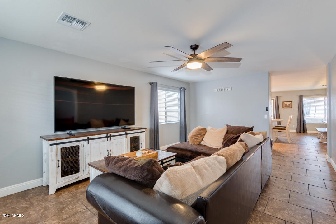 12714 West Calavar Road El Mirage, AZ 85335 - Photo 4 of 24 a living room with furniture and a flat screen tv