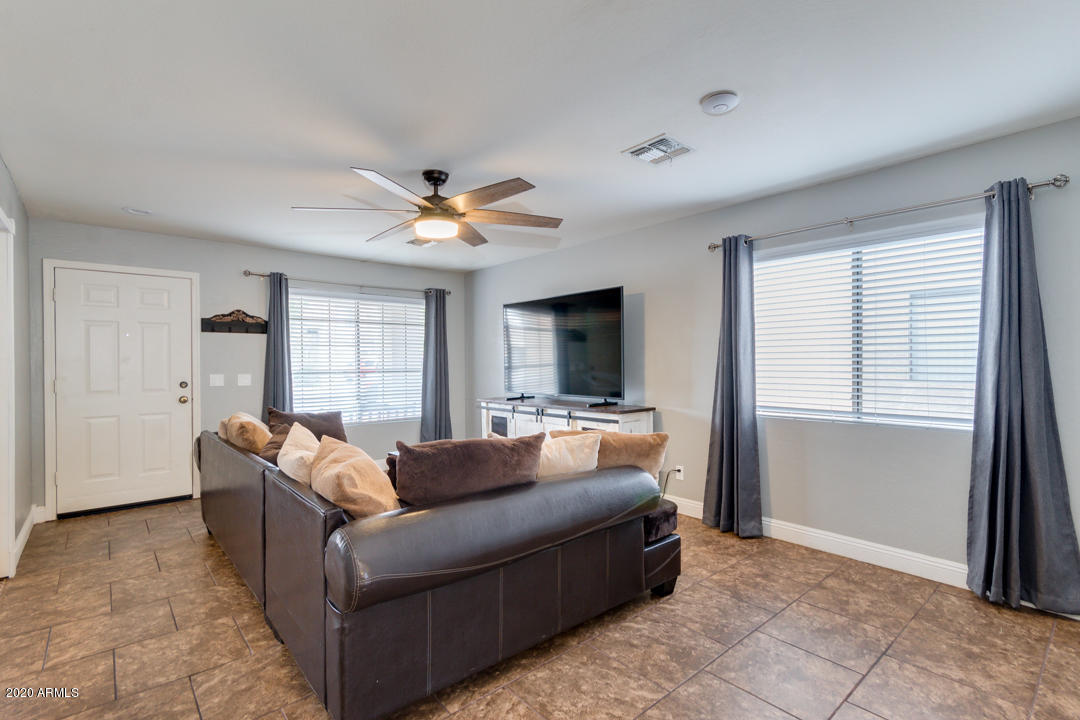 12714 West Calavar Road El Mirage, AZ 85335 - Photo 5 of 24 a living room with furniture and a flat screen tv