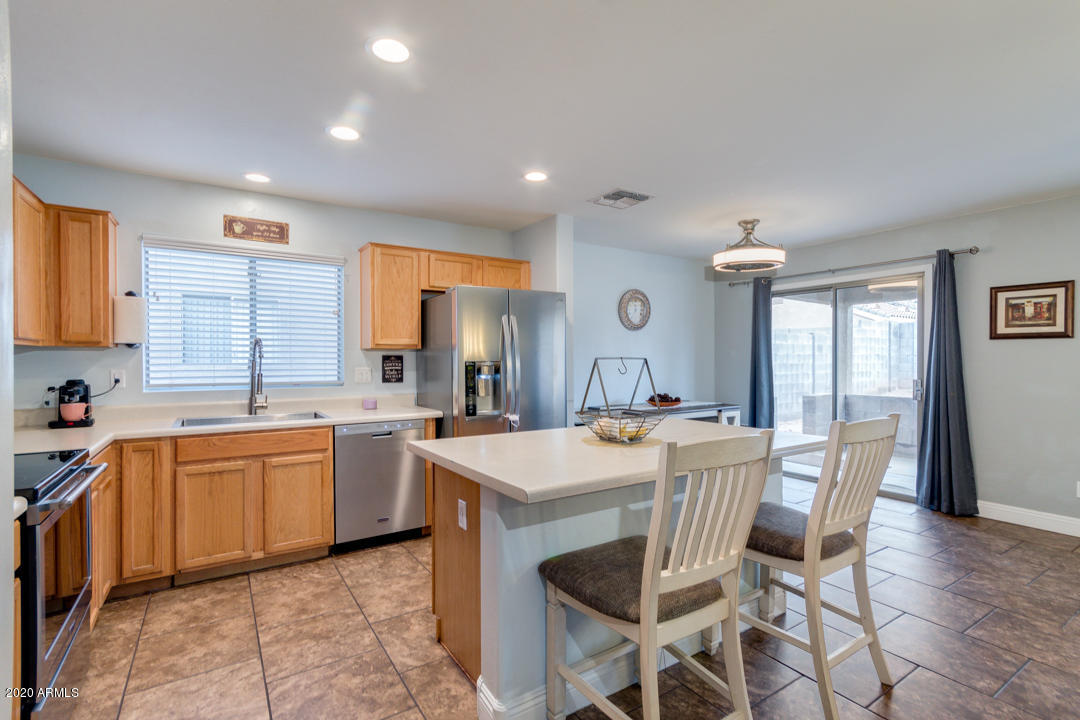 12714 West Calavar Road El Mirage, AZ 85335 - Photo 6 of 24 a large kitchen with a table and chairs