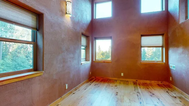 a bed sitting in a bedroom next to a lamp