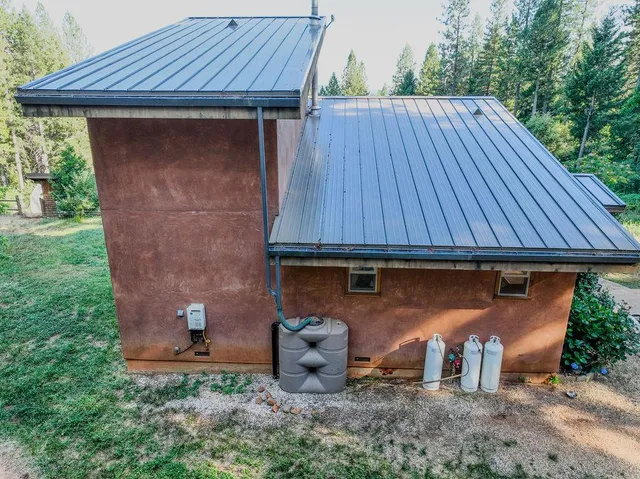 a view of a swimming pool with lawn chairs and plants