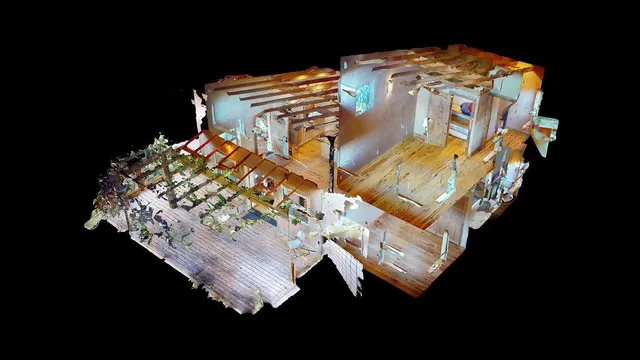 an aerial view of residential house with outdoor space and trees all around