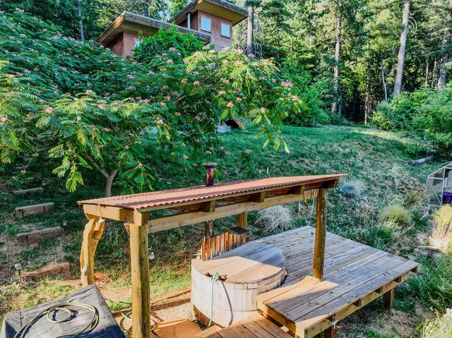 a front view of a house with a tree