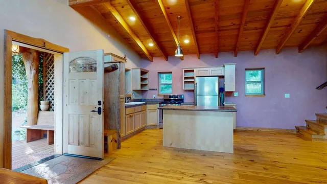 a kitchen with stainless steel appliances granite countertop a stove and cabinets