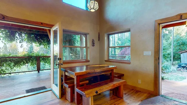 a kitchen with stainless steel appliances granite countertop a refrigerator a sink dishwasher a stove and white countertops with wooden floor