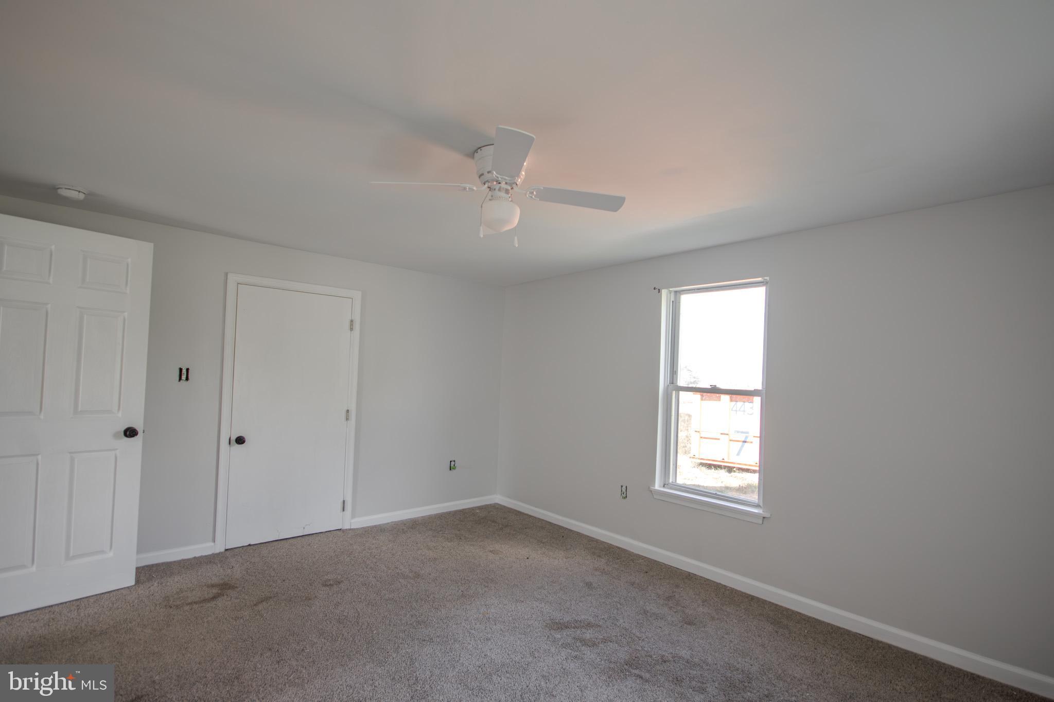 5693 Landon Store Road Marion Station, MD 21838 - Photo 12 of 20 wooden floor in an empty room with a window