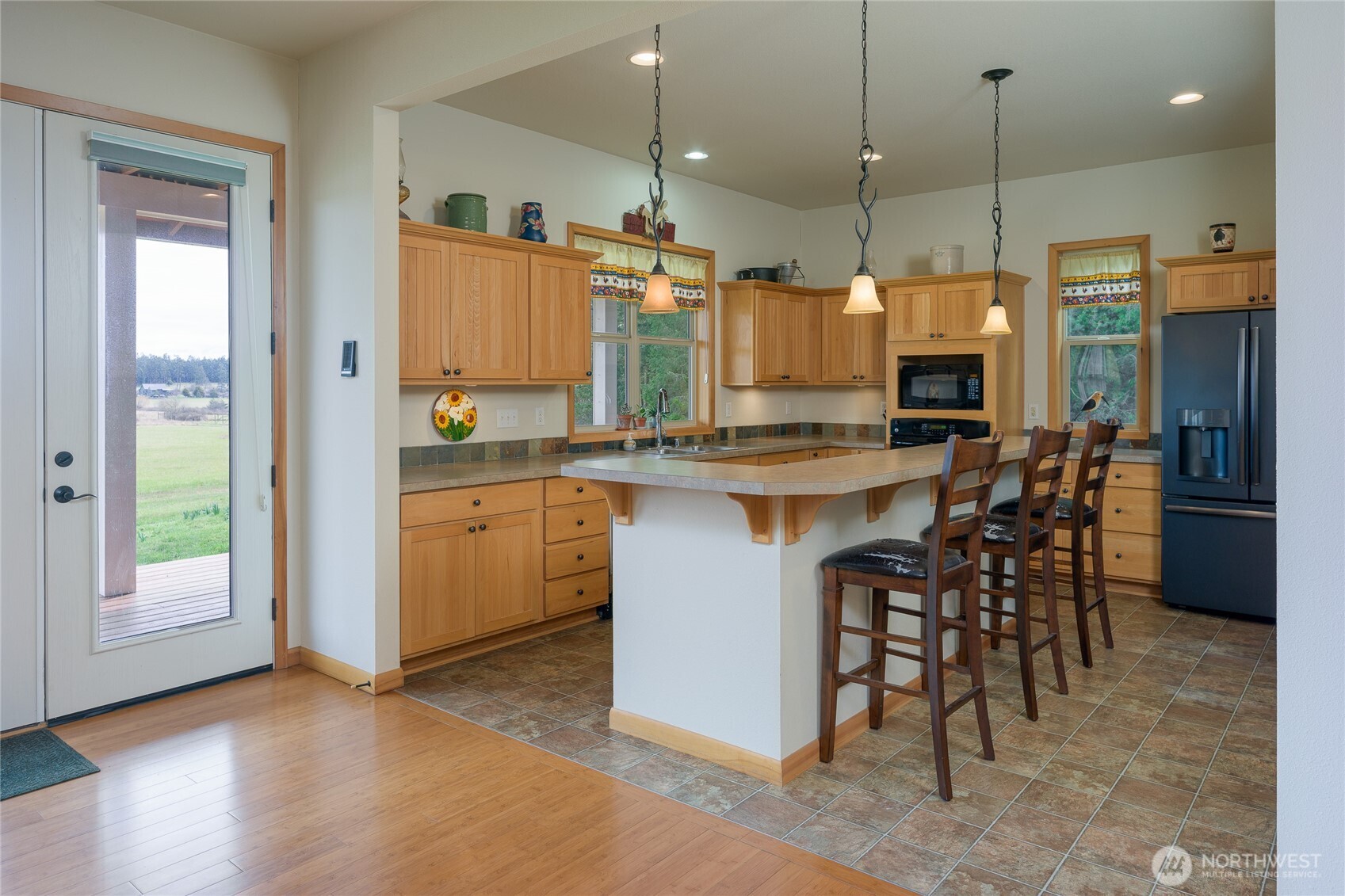 110 Clay Hill Road Lopez Island, WA 98261 - Photo 11 of 35 a kitchen with kitchen island a sink stove and refrigerator