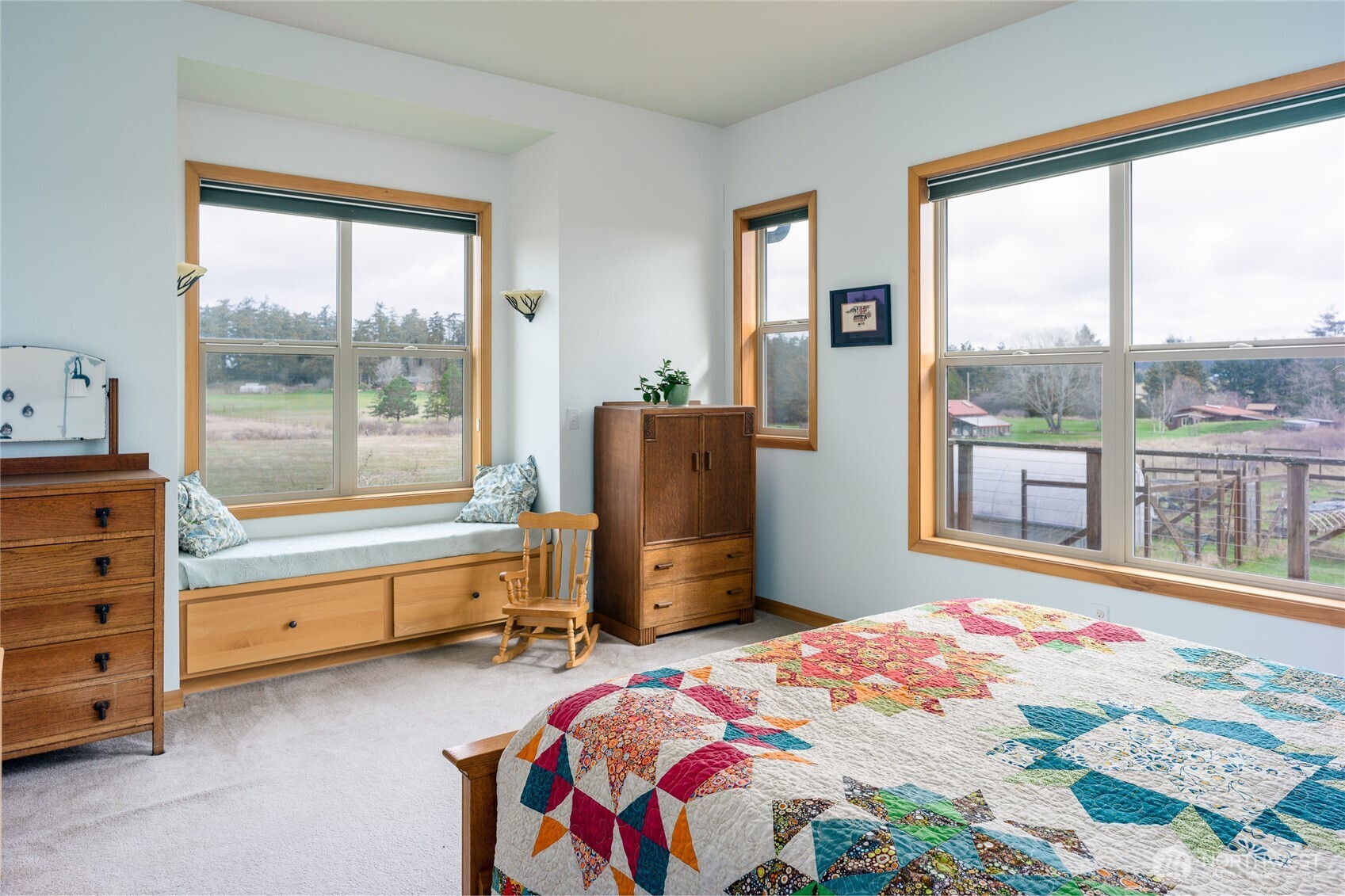 110 Clay Hill Road Lopez Island, WA 98261 - Photo 14 of 35 a bedroom with a bed and large windows
