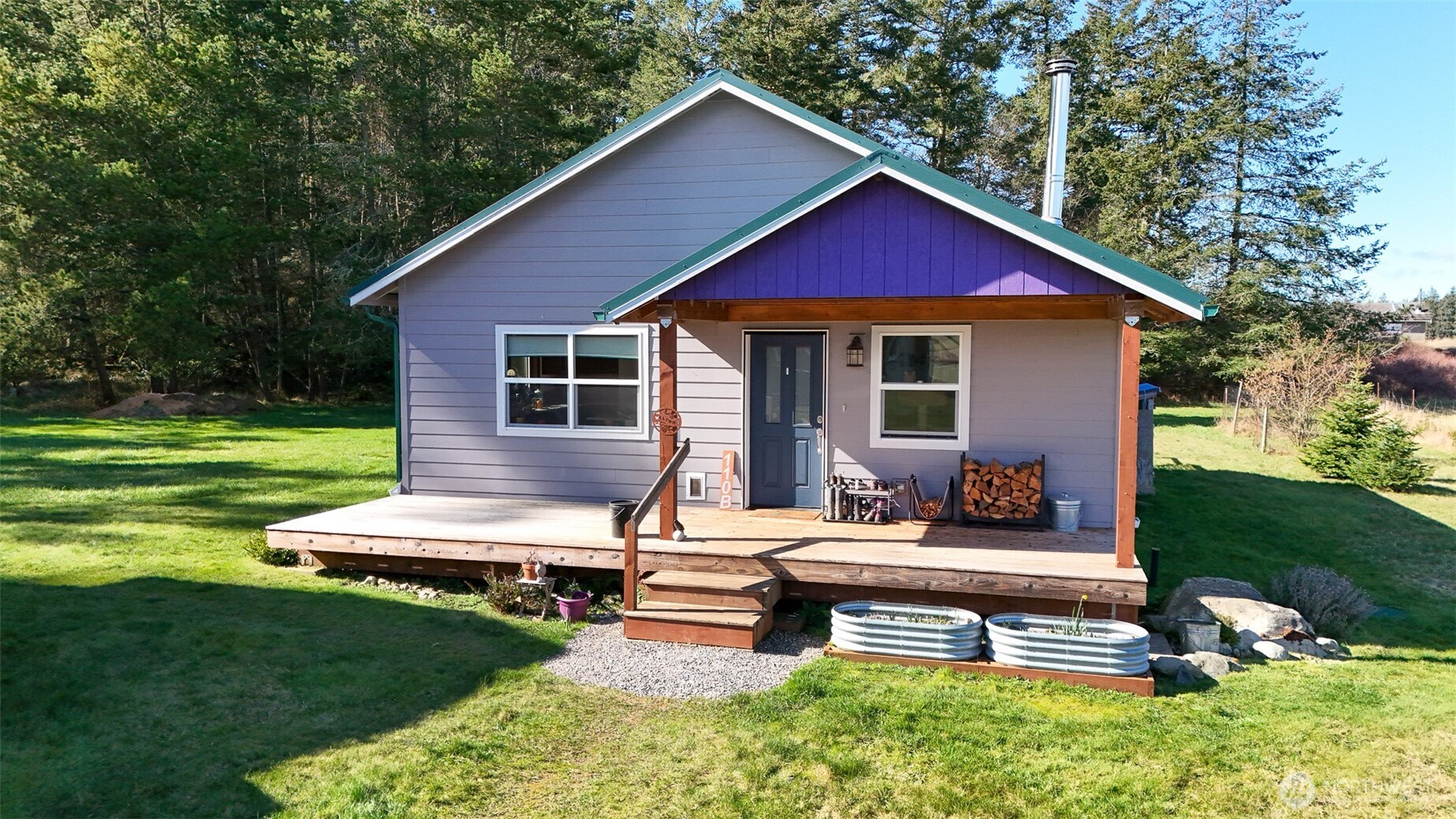 110 Clay Hill Road Lopez Island, WA 98261 - Photo 19 of 35 a view of a house with a yard patio and wooden fence