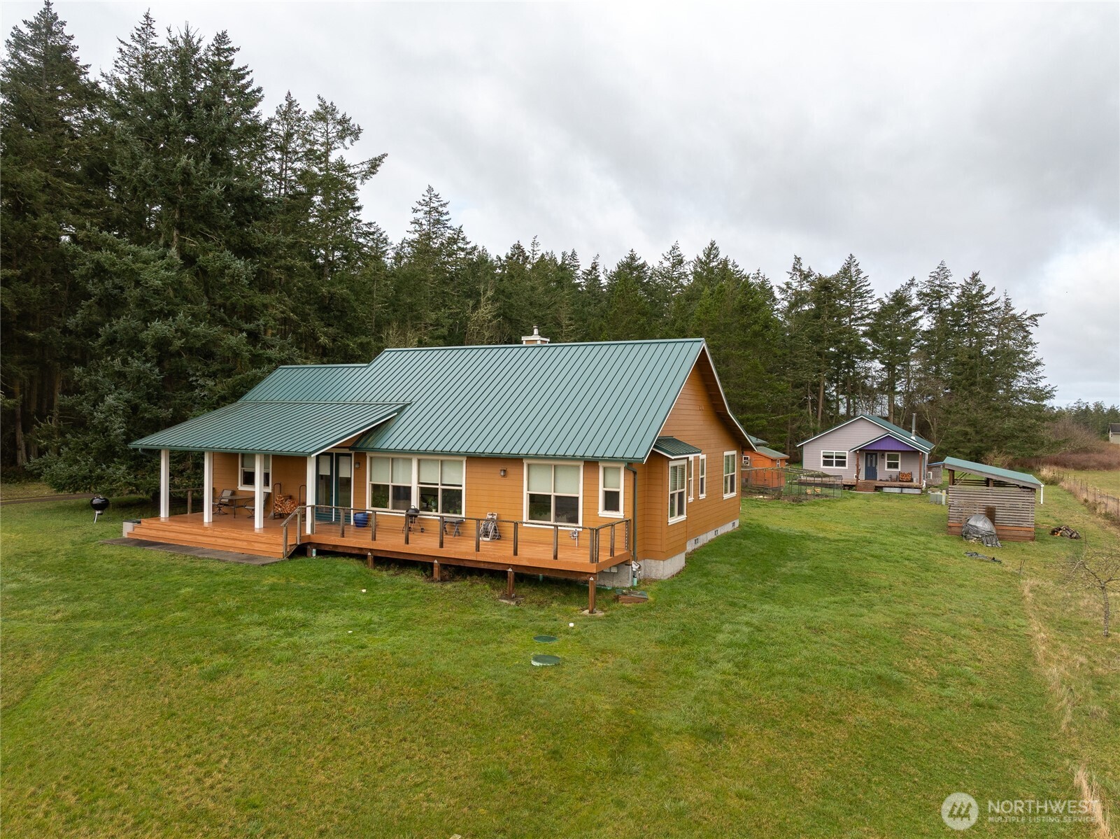 110 Clay Hill Road Lopez Island, WA 98261 - Photo 2 of 35 a view of a house with a big yard and large trees