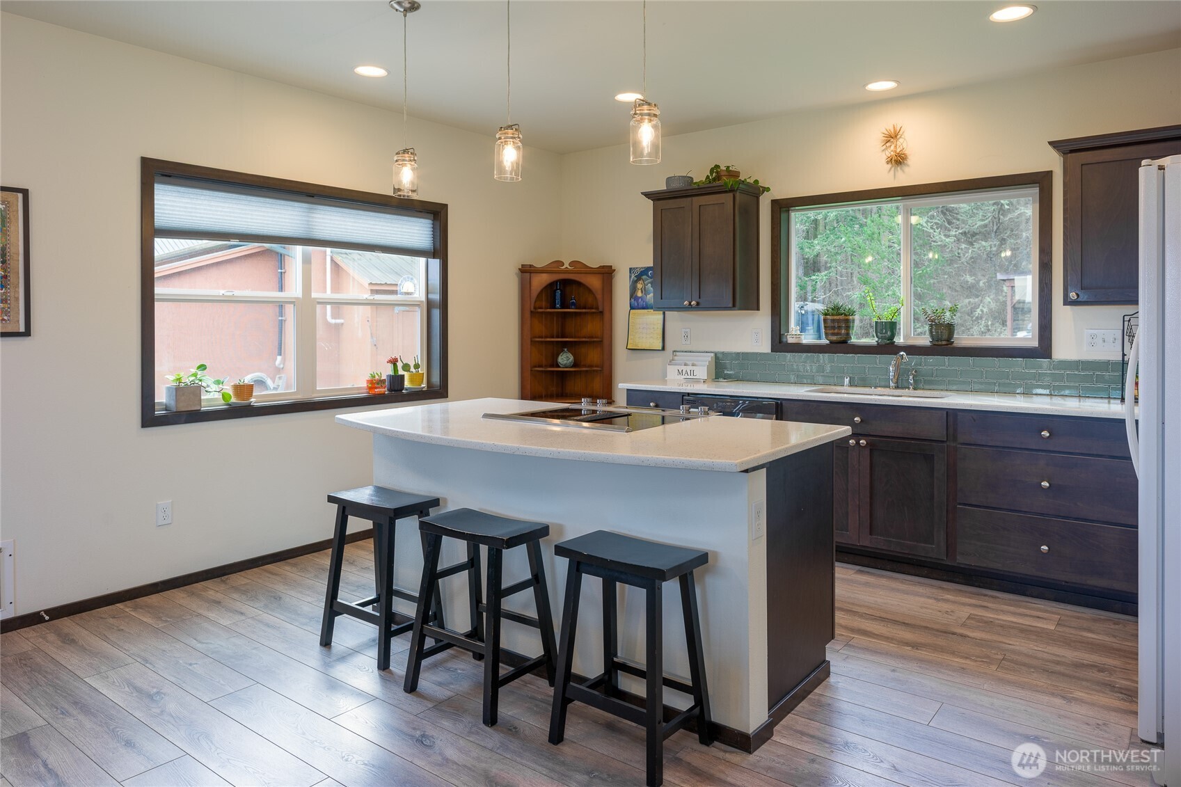 110 Clay Hill Road Lopez Island, WA 98261 - Photo 23 of 35 a kitchen with a table chairs and wooden floor