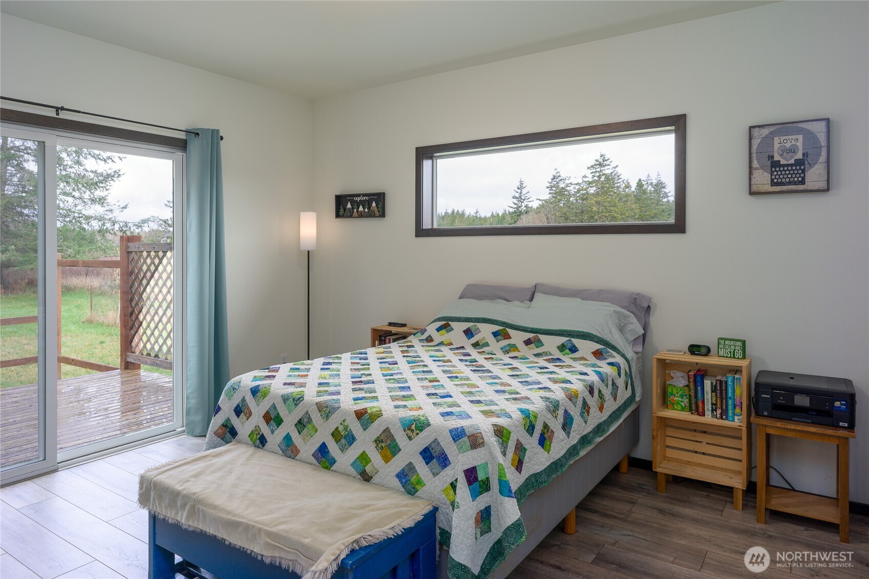110 Clay Hill Road Lopez Island, WA 98261 - Photo 25 of 35 a bedroom with a bed a dresser and a large window