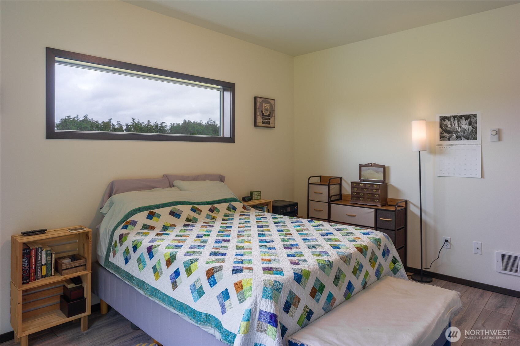 110 Clay Hill Road Lopez Island, WA 98261 - Photo 26 of 35 a bedroom with a large bed and a lamp on table