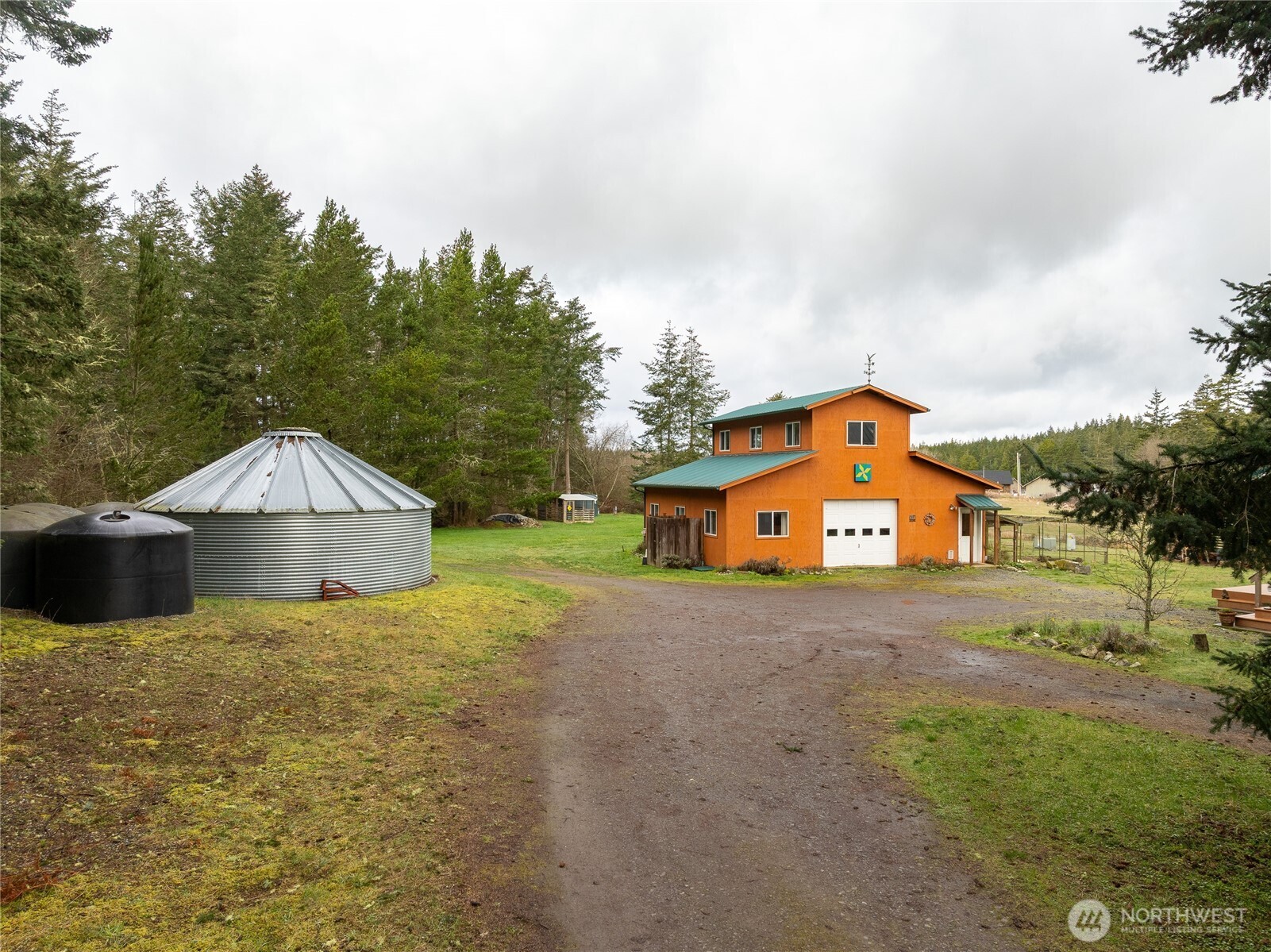 110 Clay Hill Road Lopez Island, WA 98261 - Photo 29 of 35 a front view of a house with a yard and garage
